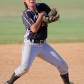 A softball player struggles to catch the ball