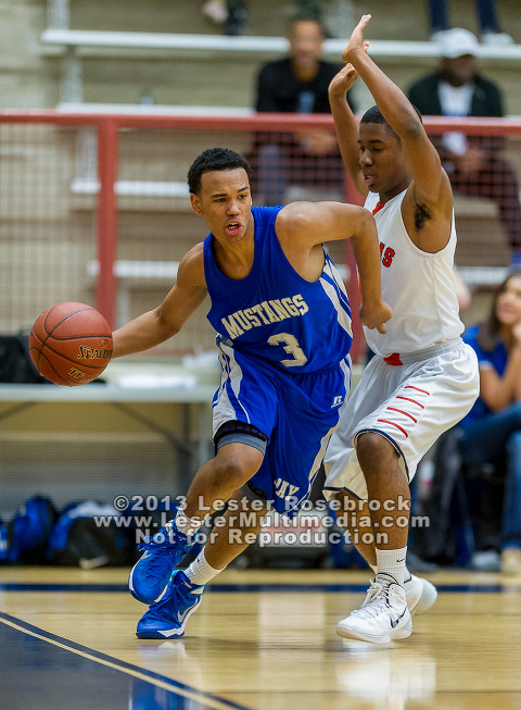 Colin Taylor of the John Jay Mustangs goes around Larry Stephens of the Brandeis Broncos during a game at O'Connor high school.  Click here for more photos.