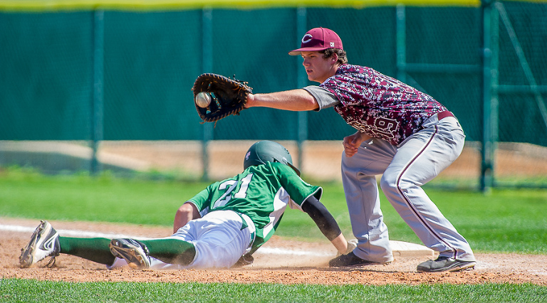 Corpus Christi Wildcats first baseman, Sean Vickers, attempts to pick off Reagan high school player during a game.   San Antonio Reagan went on to win the game 1-0 in the bottom of the 7th inning.  Click here for more photos.