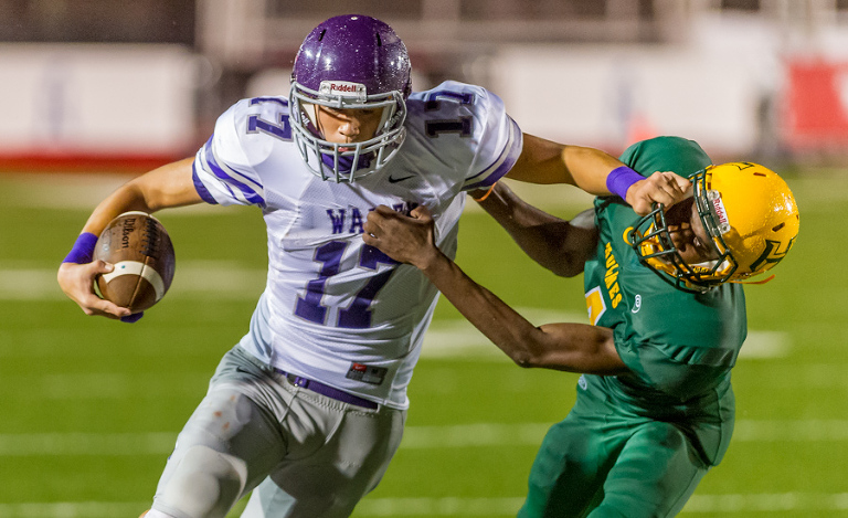 Warren player Jeremy Garcia fights off Ukash Yussufu during a game at Gustafson Stadium in San Antonio.  Click here to see more photos from the game.