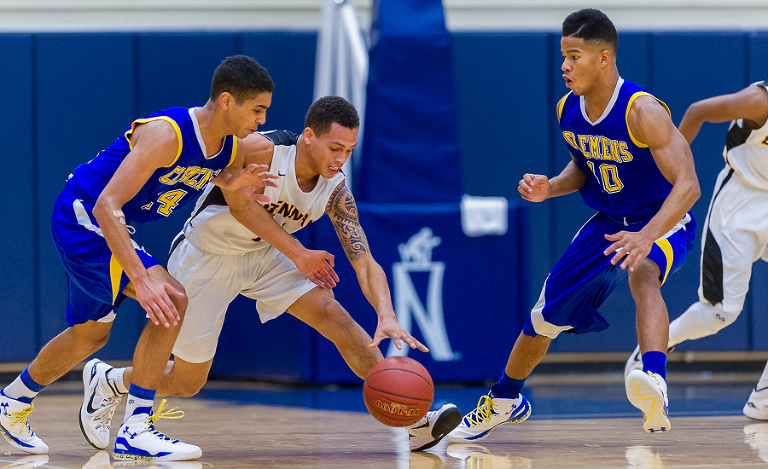 Brennan player DeShawn Key goes after the ball during a game against the Clemens Buffaloes. When covering basketball, my equipment consists of a 300mm f/2.8 and a 200mm f/2.0.  The 300mm lens is for action at the far end of the court and the 200mm is for the close basket.  Photos of the game can be purchased here. 