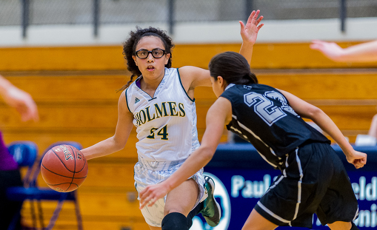 Holmes Huskies' Destiny Solis signals to the other players during a game against the Clark Cougars. For this image I used a Nikon D3s and a Nikon 300mm f/2.8 lens.