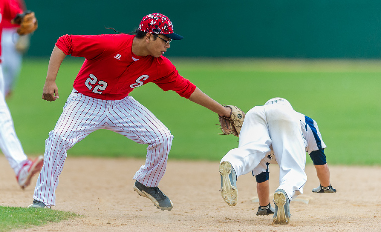 Drake Sevenstar with the Stilwell Indians (Oklahoma) nabs a Central Catholic runner before he reaches second base.