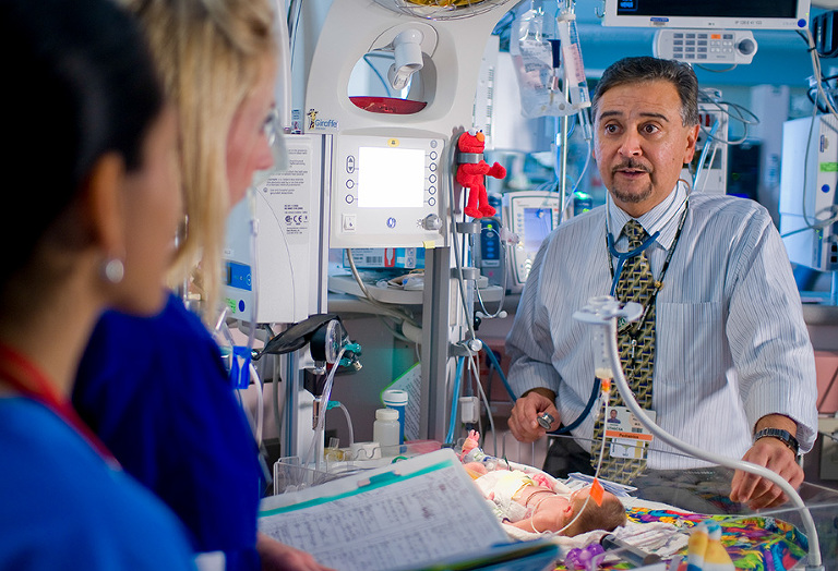 Dr. Robert Castro, UTHSCSA Pediatrics, showing new residents how to care for babies in the Pediatrics Intensive Care Unit (PICU) at University Hospital.